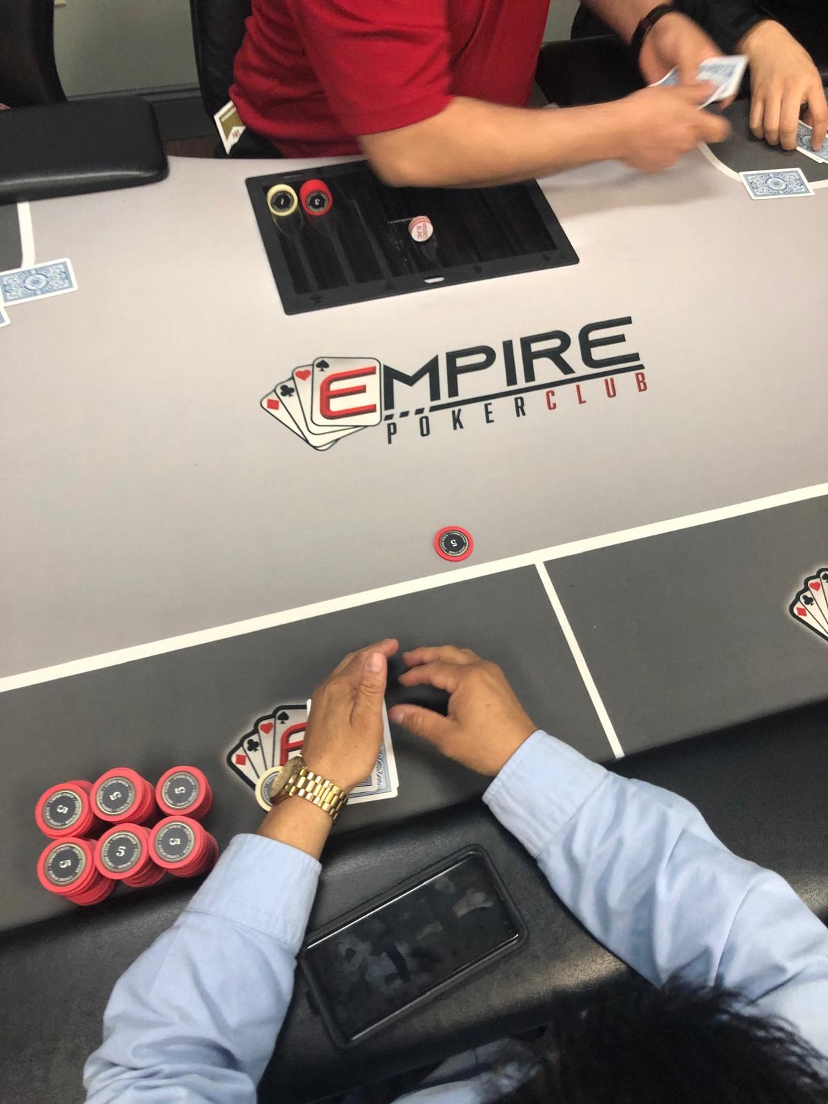 Empire Poker Club branded table with chips and cards